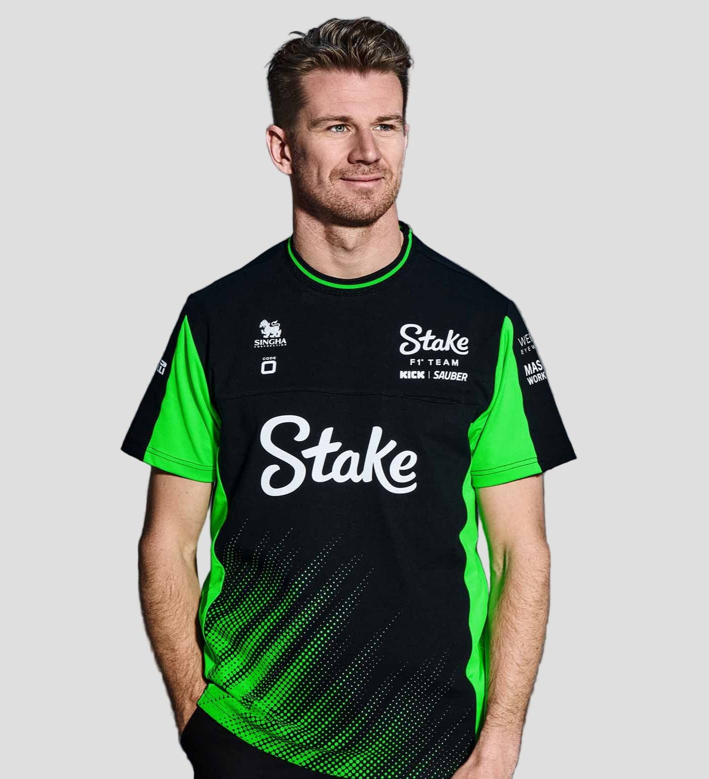 Person wearing a black and green sports jersey with 'Stake' branding on a gray background