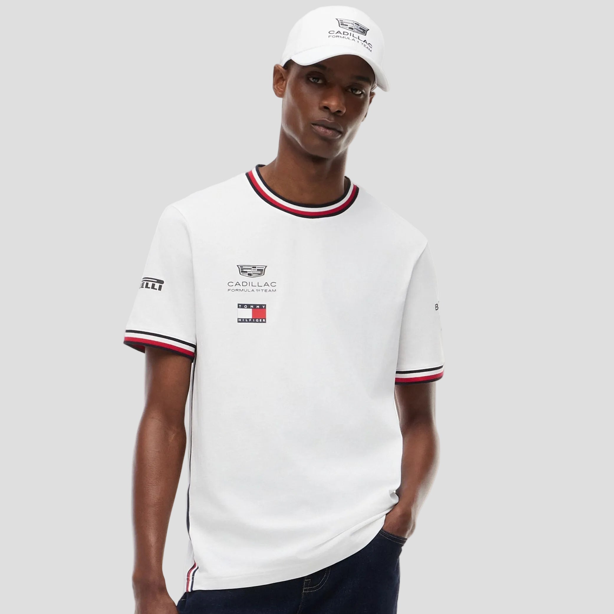 Man wearing a white t-shirt with brand logos on a white background