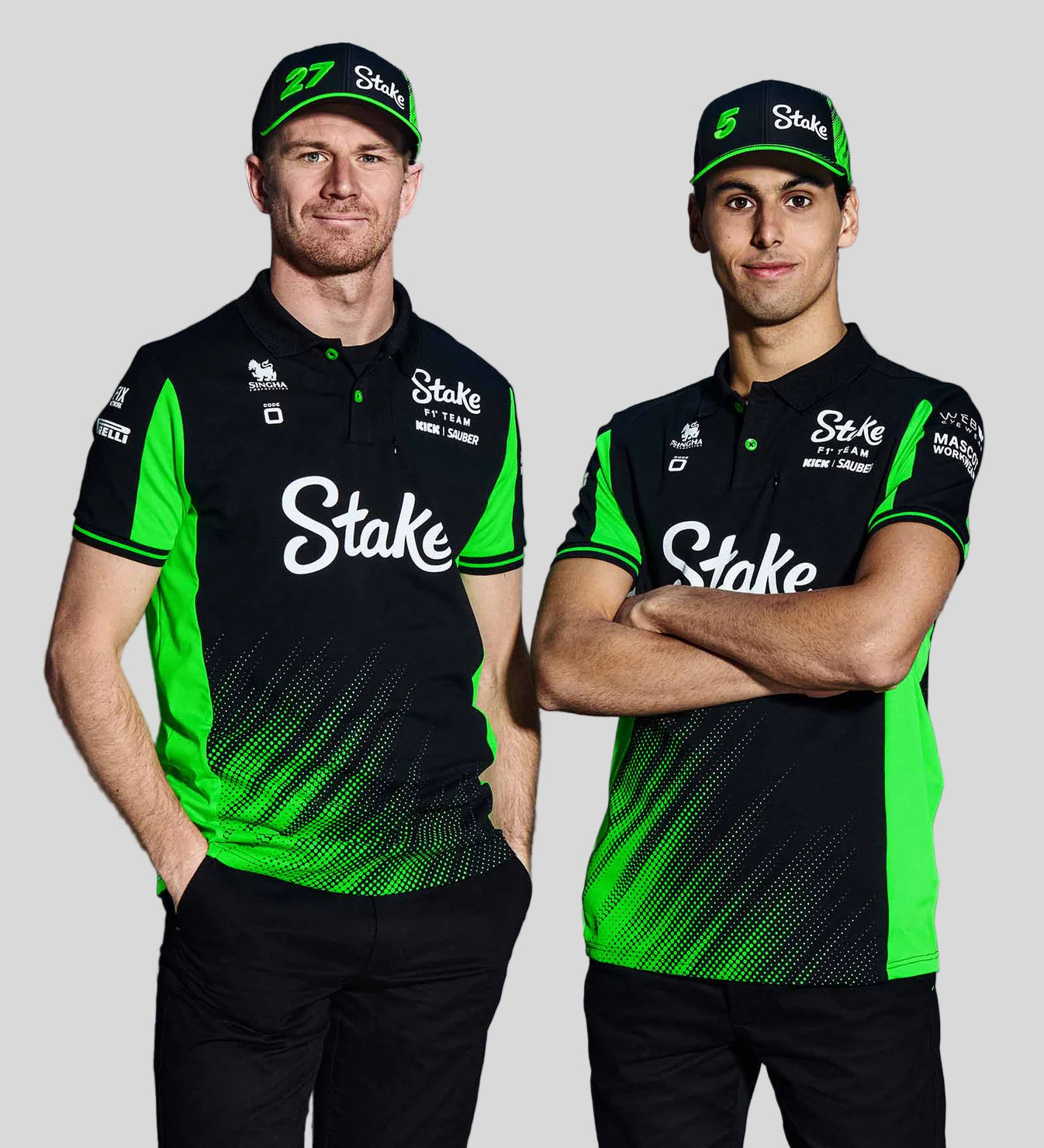 Two individuals wearing black and green sports jerseys with 'Stake' branding on a gray background.